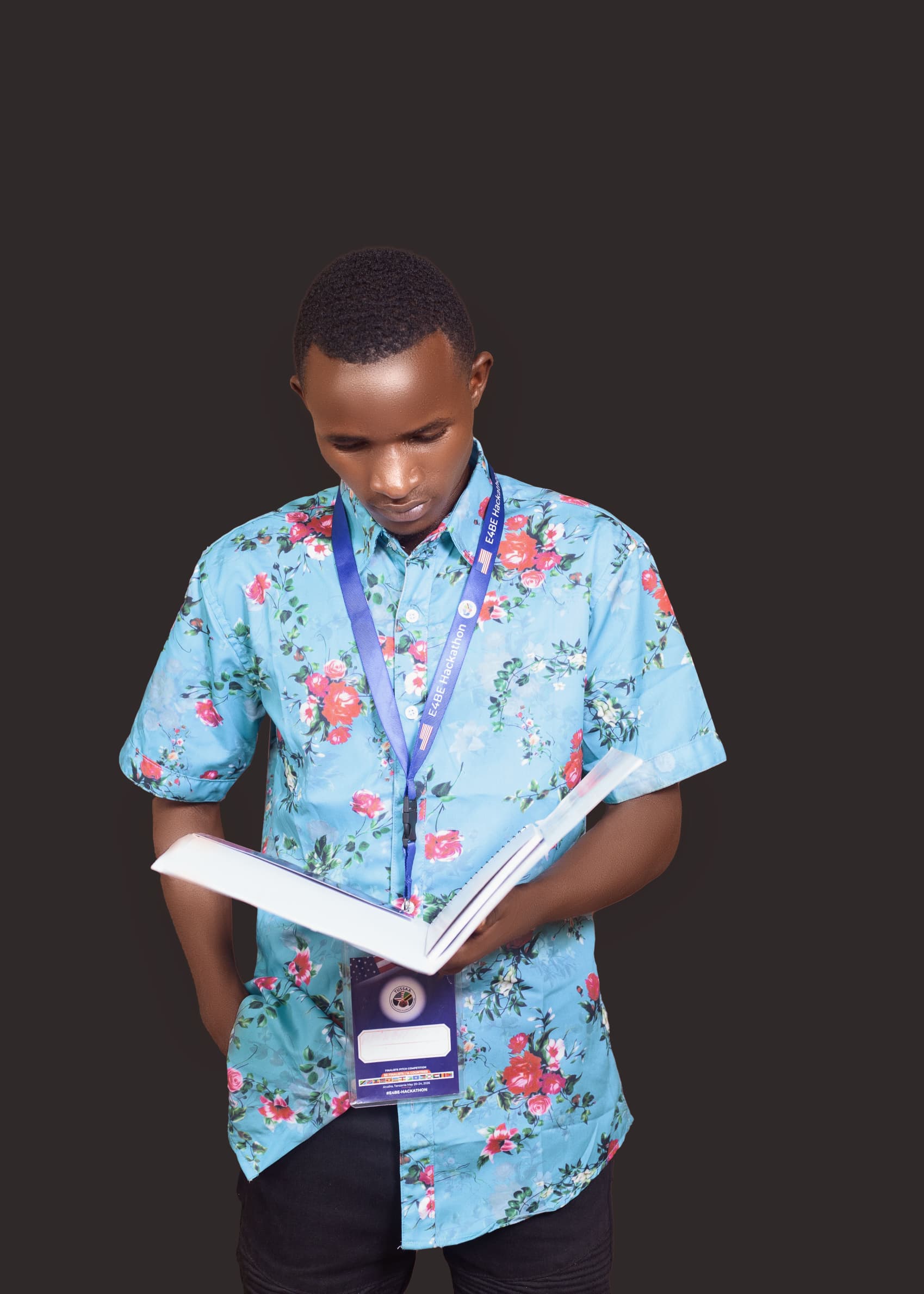 Gérard holding an open book, wearing a blue floral shirt